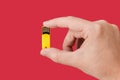 Yellow USB Flash drive on hand with isolated red background Royalty Free Stock Photo