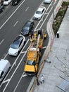 Yellow Utility Truck Unwinding Cable on South Grand Avenue in Los Angeles, California