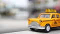 Yellow vacant mini taxi cab close up, Harmon corner, Las Vegas, USA. Small retro car model on defocused background. Little iconic Royalty Free Stock Photo