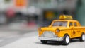 Yellow vacant mini taxi cab close up, Harmon corner, Las Vegas, USA. Small retro car model on defocused background. Little iconic Royalty Free Stock Photo