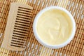 Yellow vanilla face mask banana cream, shea butter facial mask, body butter in the small white jar. Natural skin and hair care Royalty Free Stock Photo