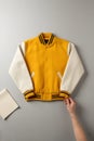 Yellow and White Varsity Jacket Mockup on Minimal Background Royalty Free Stock Photo