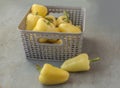 Yellow vegetable or sweet pepper in a gray basket Royalty Free Stock Photo