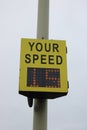 Yellow vehicle activated speed sign showing speed to driver, sign displaying 15 MPH Royalty Free Stock Photo