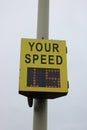 Yellow vehicle activated speed sign showing speed to driver Royalty Free Stock Photo