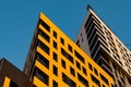 Yellow ventilated facade with Windows. A fragment of a new modern luxury residential building or commercial complex. Part of urban Royalty Free Stock Photo