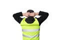 Yellow vests protests. Young man stands with his back and holds his hands on his head on isolated Royalty Free Stock Photo