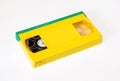 Yellow vhs video cassette with green curtain on white background, front side Royalty Free Stock Photo
