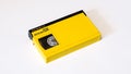 Yellow videocassette with dark shutter betacam sx format on white background