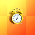 Yellow vintage alarm clock with shadow