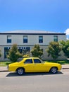 Yellow vintage Australian classic Holden Kingswood sedan car parked on the historic Richmond street