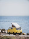 Yellow vintage camper van with pop-up roof Royalty Free Stock Photo