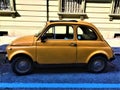 Yellow vintage Fiat 500 car. History, travel, fashion, colours and Italian style