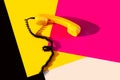 Retro vintage phone handset yellow pink red purple plastic orange disko background old style shadow 90 black Royalty Free Stock Photo