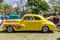 Yellow vintage hot rod with flames painted on the hood Royalty Free Stock Photo