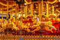 Yellow Vintage merry-go-round wooden horses in carusel