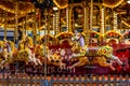 Yellow Vintage merry-go-round wooden horses in carusel