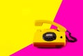 Retro vintage phone handset yellow pink red purple plastic orange disko background old style shadow 90 answer reply raised Royalty Free Stock Photo