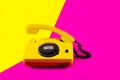 Retro vintage phone handset yellow pink red purple plastic orange disko background old style shadow 90 answer reply raised Royalty Free Stock Photo