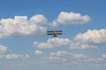 Yellow vintage plane flies in the clouds Royalty Free Stock Photo