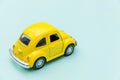 Yellow vintage retro toy car isolated on blue pastel colorful background Royalty Free Stock Photo