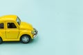 Yellow vintage retro toy car  on blue pastel colorful background Royalty Free Stock Photo