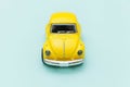 Yellow vintage retro toy car isolated on blue pastel colorful background Royalty Free Stock Photo