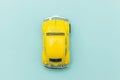 Yellow vintage retro toy car isolated on blue pastel colorful background Royalty Free Stock Photo