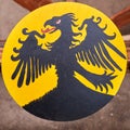 Yellow vintage shield with an black eagle a medieval warrior. Reconstruction of the events of the Middle Ages in Europe