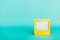 yellow vintage televisor on turquoise background