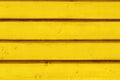 Yellow vintage wooden boards in overlap cladding pattern