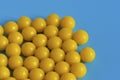 Yellow vitamins on a blue background. Vitamin complex against the virus. Multivitamins to enhance health and immunity.