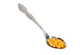 Yellow vitamins on spoon Royalty Free Stock Photo