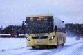 Yellow Volvo Bus Transports Passengers in Winter Snowfall Royalty Free Stock Photo