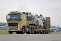 Yellow Volvo FH Hauls Heavy Machinery