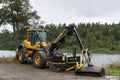 Yellow Volvo loader with grass cutter