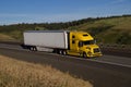 Yellow Volvo Semi-Truck / White Trailer