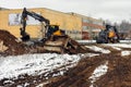 Yellow Volvo wheeled excavators at work site