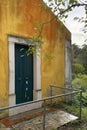 Yellow wall and blue door in a small village, Tuscany, Italy Royalty Free Stock Photo