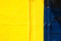 Yellow wall and blue metal door Royalty Free Stock Photo