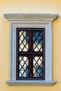 Yellow wall of a building and window with grille Royalty Free Stock Photo