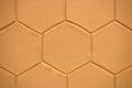 Yellow wall with engraved hexagonal geometric shapes