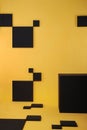 Yellow wall and floor with black squares and black box