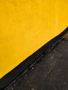 Yellow wall of the house and black asphalt. Screensaver on your desktop. Royalty Free Stock Photo