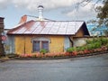 A yellow wall house with a white tall chimney