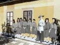 Yellow wall with a trompe l'oeil of students in uniform to Cetinje in Montenegro.