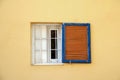 Yellow Wall, White Window, Blue Shutters Royalty Free Stock Photo