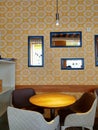 Yellow wallpapers and mirrors in cafe interior