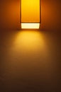 Yellow warm light from the wall lamp. Royalty Free Stock Photo