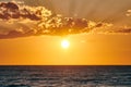 Yellow warm sun over deep blue sea at scenic sunset sky, endless sea in warm bright sunlight Royalty Free Stock Photo